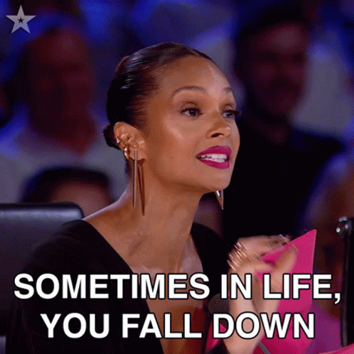 A Woman Sitting In Front Of A Crowd With The Words " Sometimes In Life You Fall Down " GIF
