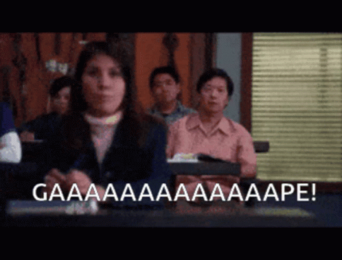 A Woman Sitting In Front Of A Group Of People With The Words Gaaaa Written On The Bottom GIF