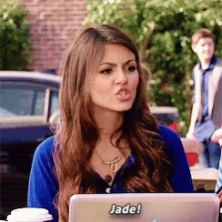 A Woman Sitting In Front Of A Laptop With A Sticker That Says Jade On It GIF