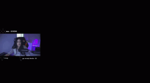 A Woman Sitting In Front Of A Microphone With A Number 8 In The Background GIF