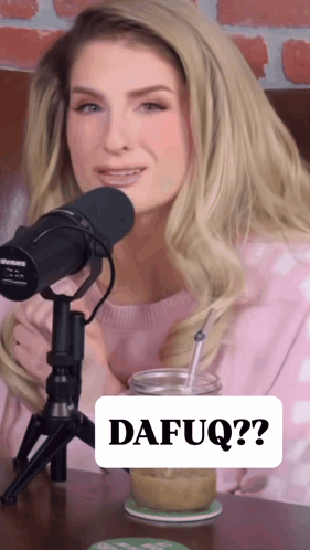 A Woman Sitting In Front Of A Microphone With A Sign That Says Dafuq On It GIF