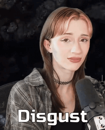A Woman Sitting In Front Of A Microphone With The Word Disgust Written On The Bottom GIF
