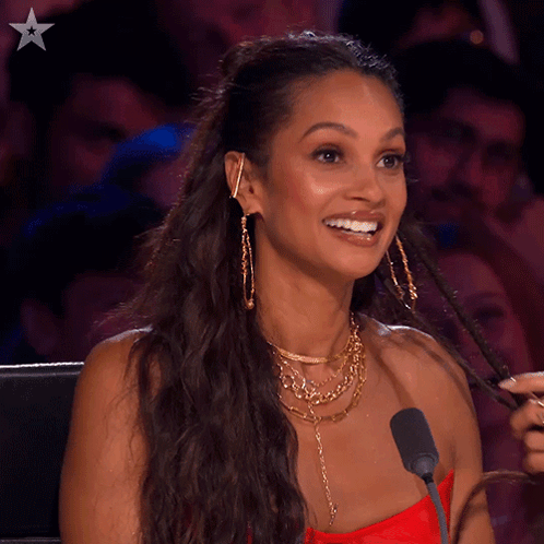 A Woman Sitting In Front Of A Microphone With The Word Never Behind Her GIF