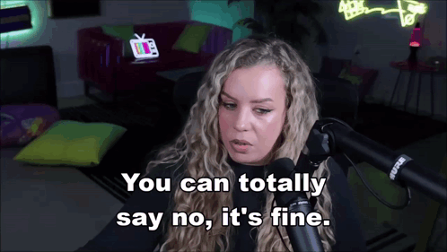 A Woman Sitting In Front Of A Microphone With The Words You Can Totally Say No It 'S Fine GIF