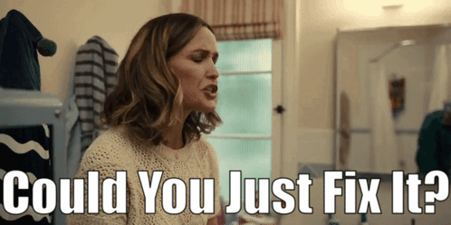 A Woman Sitting In Front Of A Mirror With The Words " Could You Just Fix It " Above Her GIF