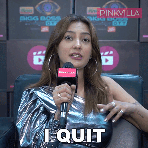 A Woman Sitting In Front Of A Pinkvilla Sign Holding A Microphone And Saying I Quit GIF