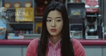 A Woman Sitting In Front Of A Sign That Says Resume At The Top GIF