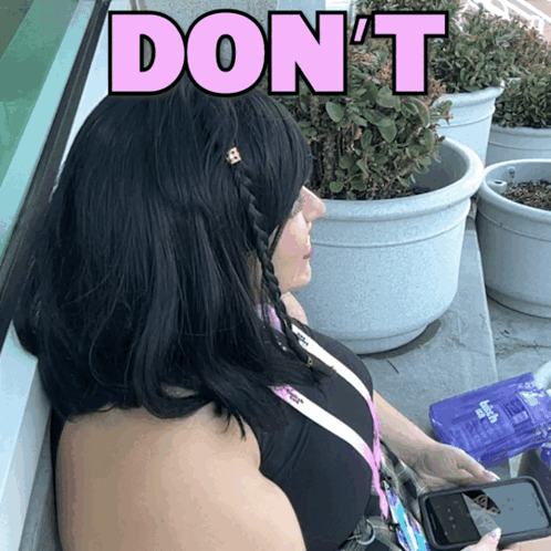 a woman sitting in front of potted plants with the words " do n't " above her head