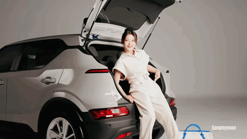 A Woman Sitting In The Back Of A Car With The Word Hangmyeon Behind Her GIF