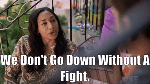 A Woman Sitting On A Balcony With The Words We Don T Go Down Without A Fight Above Her GIF