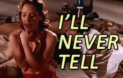A Woman Sitting On A Bed With The Words " I 'Ll Never Tell " GIF