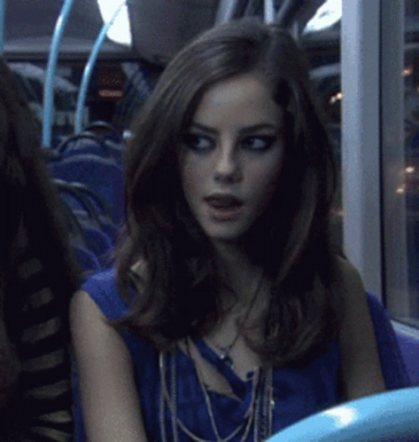 A Woman Sitting On A Bus With A Blue Shirt On GIF
