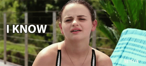 A Woman Sitting On A Chair With The Words " I Know " Above Her GIF
