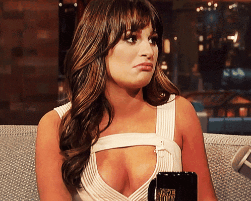A Woman Sitting On A Couch Holding A Coffee Mug That Says Caffeine Free GIF
