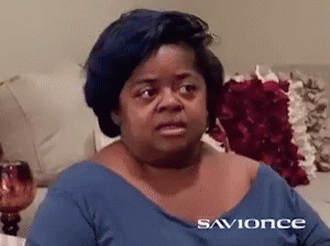 A Woman Sitting On A Couch Wearing A Blue Shirt That Says Savionce On It GIF