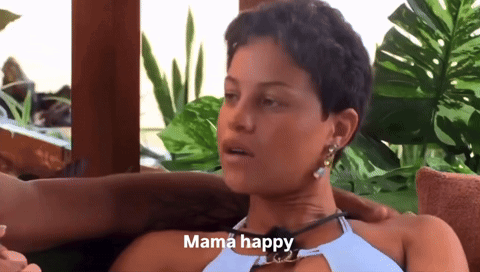 A Woman Sitting On A Couch With A Caption That Says Mama Happy GIF