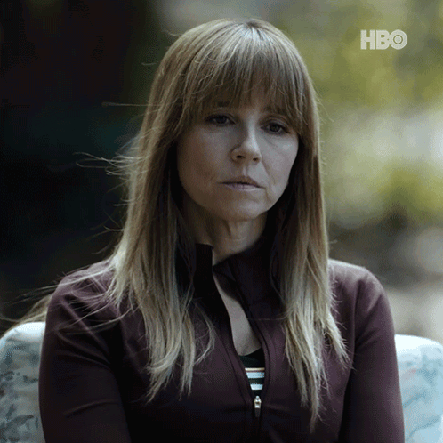 a woman sitting on a couch with hbo written on the bottom right