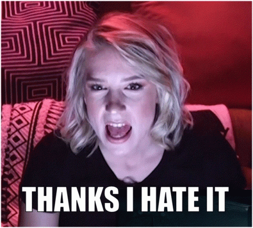 A Woman Sitting On A Couch With Her Mouth Open And The Words Thanks I Hate It GIF