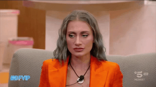 A Woman Sitting On A Couch With The Hashtag #Gfvip On The Screen GIF