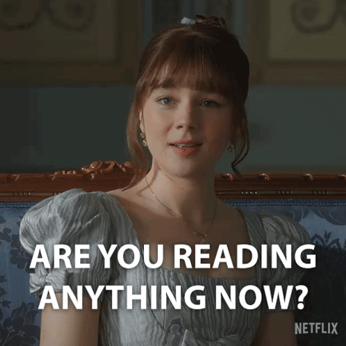 A Woman Sitting On A Couch With The Words " Are You Reading Anything Now " On The Bottom GIF