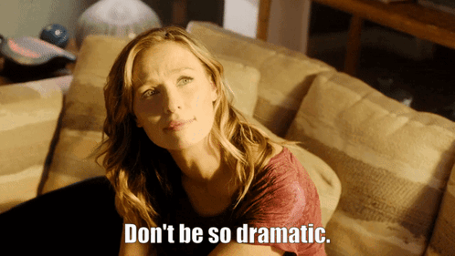 A Woman Sitting On A Couch With The Words " Don 'T Be So Dramatic " Written On The Bottom GIF