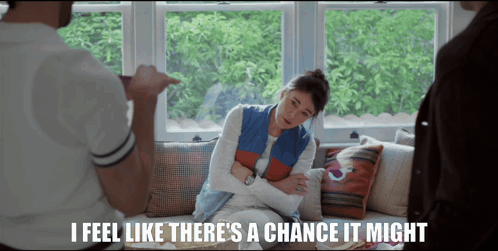 A Woman Sitting On A Couch With The Words " I Feel Like There 'S A Chance It Might " Below Her GIF