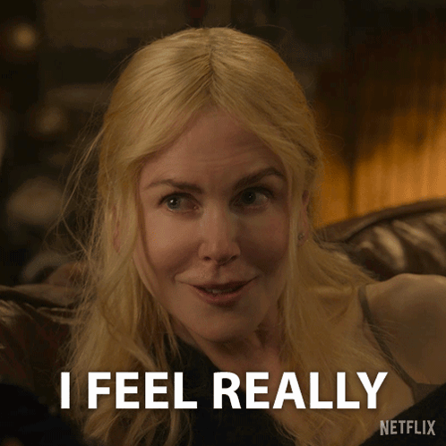 A Woman Sitting On A Couch With The Words I 'M With Him Above Her GIF