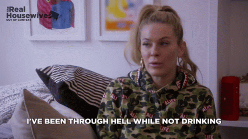 A Woman Sitting On A Couch With The Words I 'Ve Been Through Hell While Not Drinking GIF