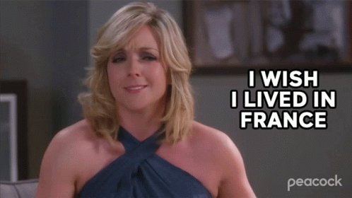 A Woman Sitting On A Couch With The Words I Wish I Lived In France Above Her GIF