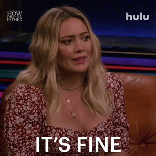 A Woman Sitting On A Couch With The Words " It 'S Fine " On Her Face GIF