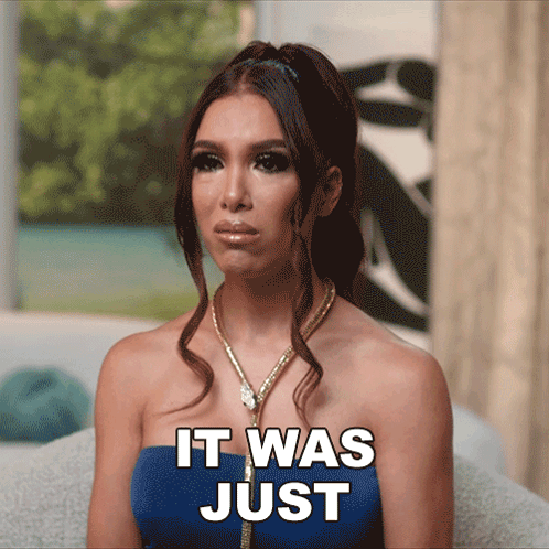 A Woman Sitting On A Couch With The Words " It Was Just " On Her Face GIF