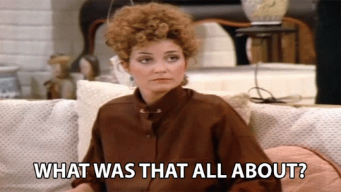 A Woman Sitting On A Couch With The Words What Was That All About GIF