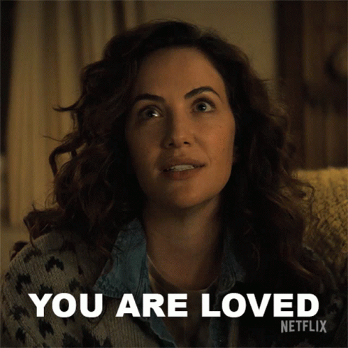 A Woman Sitting On A Couch With The Words " You Are Loved " Written On It GIF