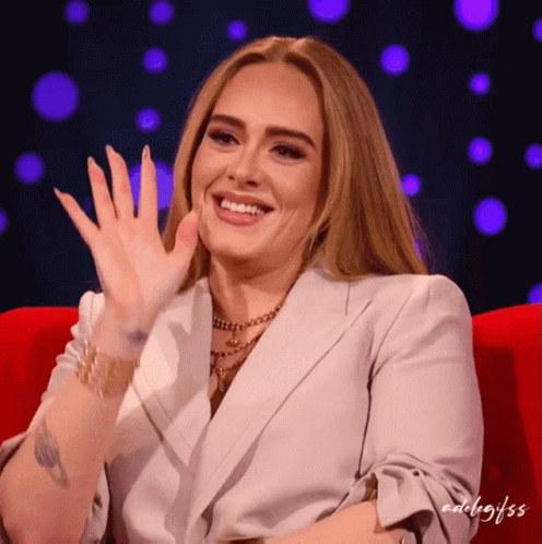 A Woman Sitting On A Red Couch With The Word Edelgifss On The Bottom GIF