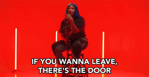 Woman Sitting On Stool Saying If You Wanna Leave There's The Door GIF
