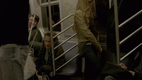 A Woman Sitting On A Train With A Bag That Says ' Subway ' On It GIF