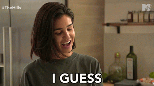 a woman smiles and says i guess in a kitchen