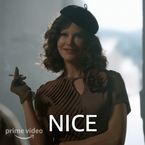 A Woman Smoking A Cigarette With The Word Nice On The Bottom Right GIF