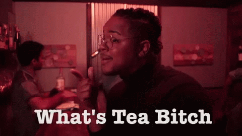 A Woman Smoking A Cigarette With The Words " What 'S Tea Bitch " Below Her GIF