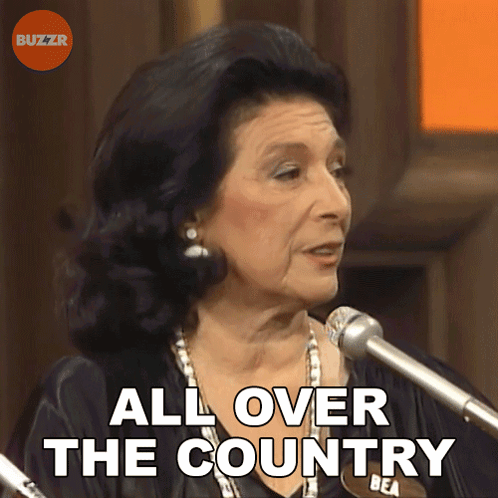 A Woman Speaking Into A Microphone With The Words " All Over The Country " Behind Her GIF