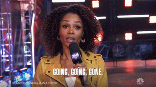 A Woman Speaking Into A Microphone With The Words Going Going Gone Behind Her GIF