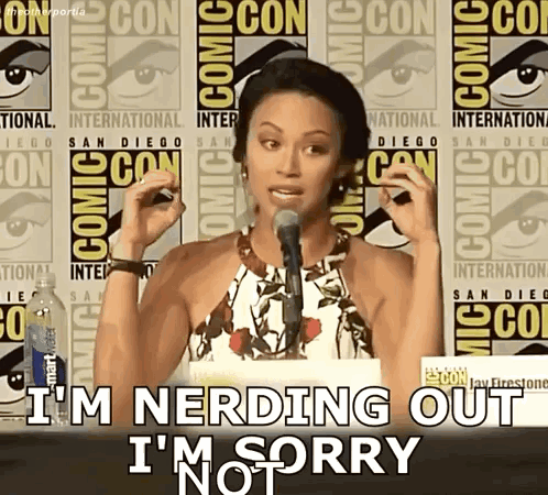 A Woman Speaking Into A Microphone With The Words I 'M Nerding Out I 'M Sorry Behind Her GIF