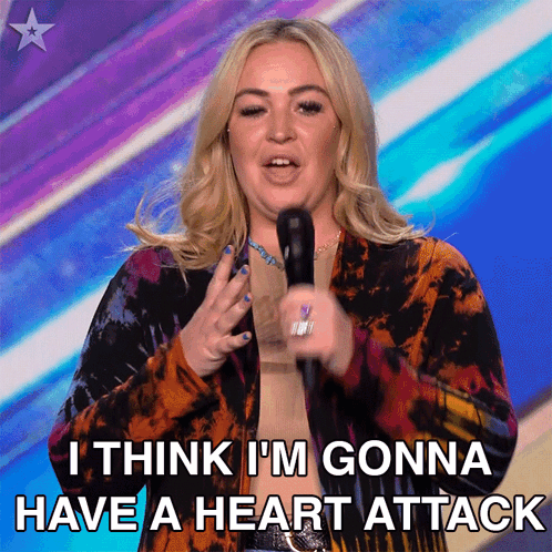 A Woman Speaking Into A Microphone With The Words " I Think I 'M Gonna Have A Heart Attack " Below Her GIF