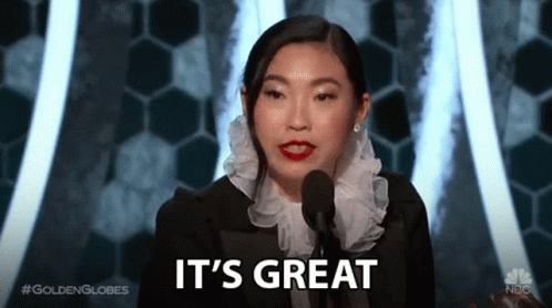 A Woman Speaking Into A Microphone With The Words It 'S Great Behind Her GIF