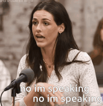 A Woman Speaking Into A Microphone With The Words " No Im Speaking No Im Speaking " Above Her GIF