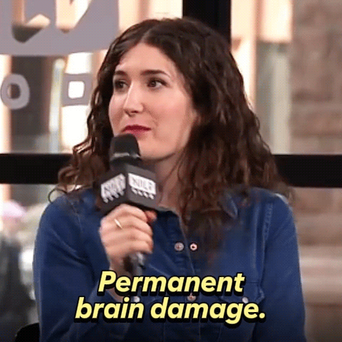 A Woman Speaking Into A Microphone With The Words Permanent Brain Damage Behind Her GIF