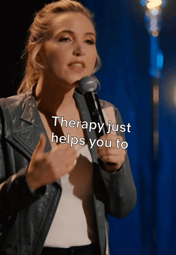 A Woman Speaking Into A Microphone With The Words " Therapy Just Helps You To " Above Her GIF