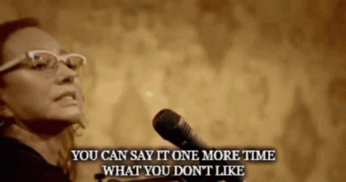 A Woman Speaking Into A Microphone With The Words " You Can Say It One More Time What You Don 'T Like " Below Her GIF