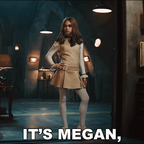 A Woman Standing In A Dark Room With The Words It 'S Megan Below Her GIF