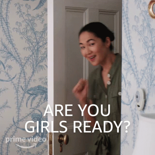 A Woman Standing In A Doorway With The Words " Are You Girls Ready " Written On The Bottom GIF